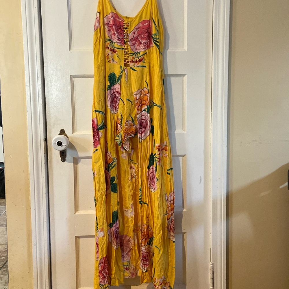 I am selling a romper with a long back. It’s a mustard yellow with pink roses